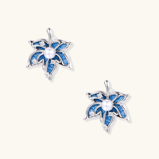 Blue denim fabric star-flower stud earrings with white pearl center and crystal accents on white gold-plated frame