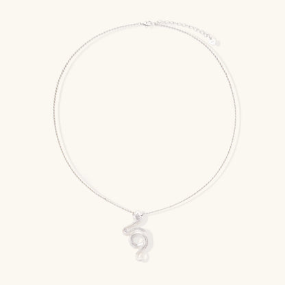 Abstract S-curve sterling silver pendant with zirconia accents on delicate chain against white background