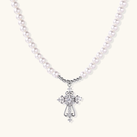 White pearl beaded necklace with ornate crystal-embellished cross pendant on white background, white gold plated finish