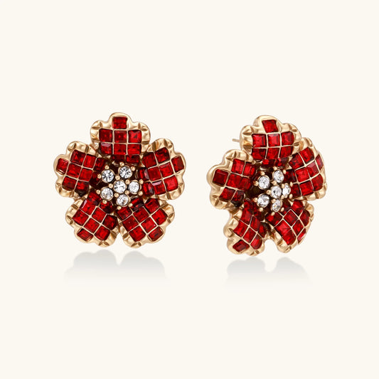 Gold-plated flower studs with burgundy square crystals in petal mosaic and clear center stones on beige background.