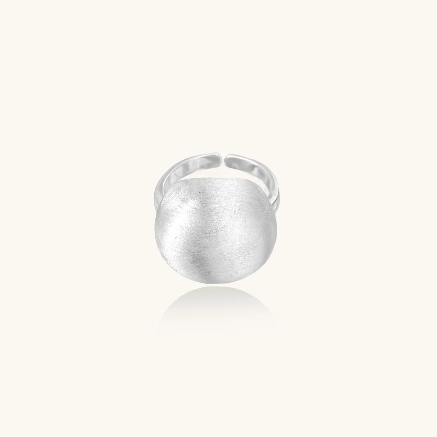 Minimalist brushed sterling silver dome ring with adjustable band on white background, front view.