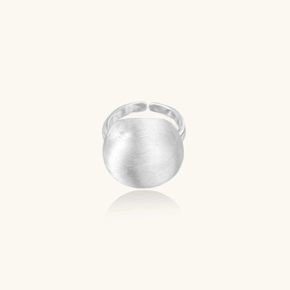 Minimalist brushed sterling silver dome ring with adjustable band on white background, front view.