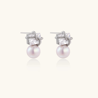 White gold stud earrings with square crystal stones in twisted frames and pink freshwater pearl drops below