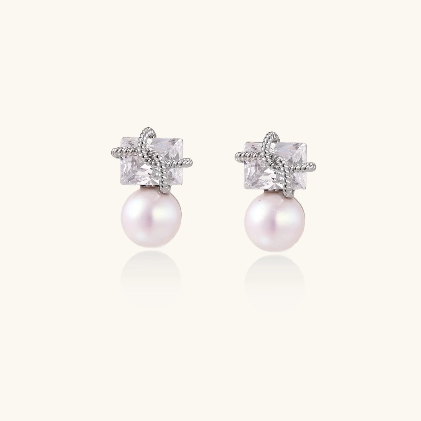 White gold stud earrings with square crystal stones in twisted frames and pink freshwater pearl drops below